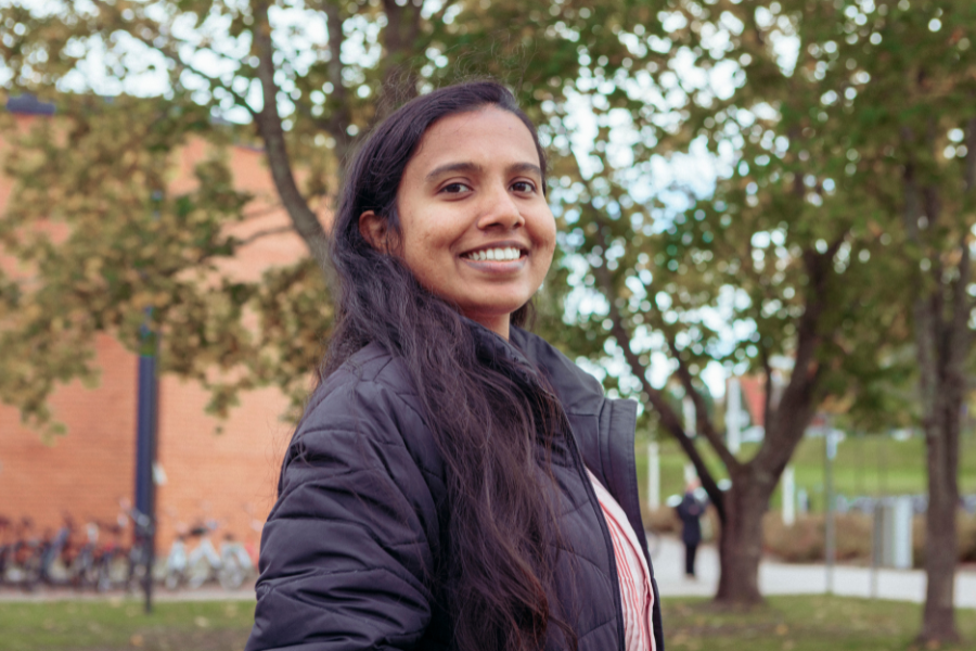 A student smiling at a Finnish university campus