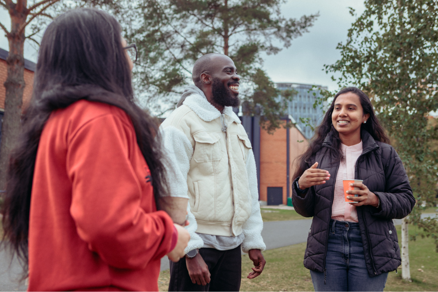 A group of students chatting at university campus
