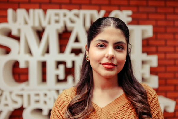 A female student in front of university advertisement