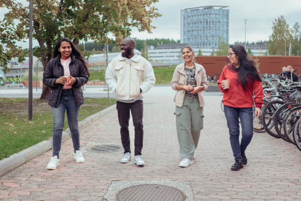 A group of students walking outside and chatting
