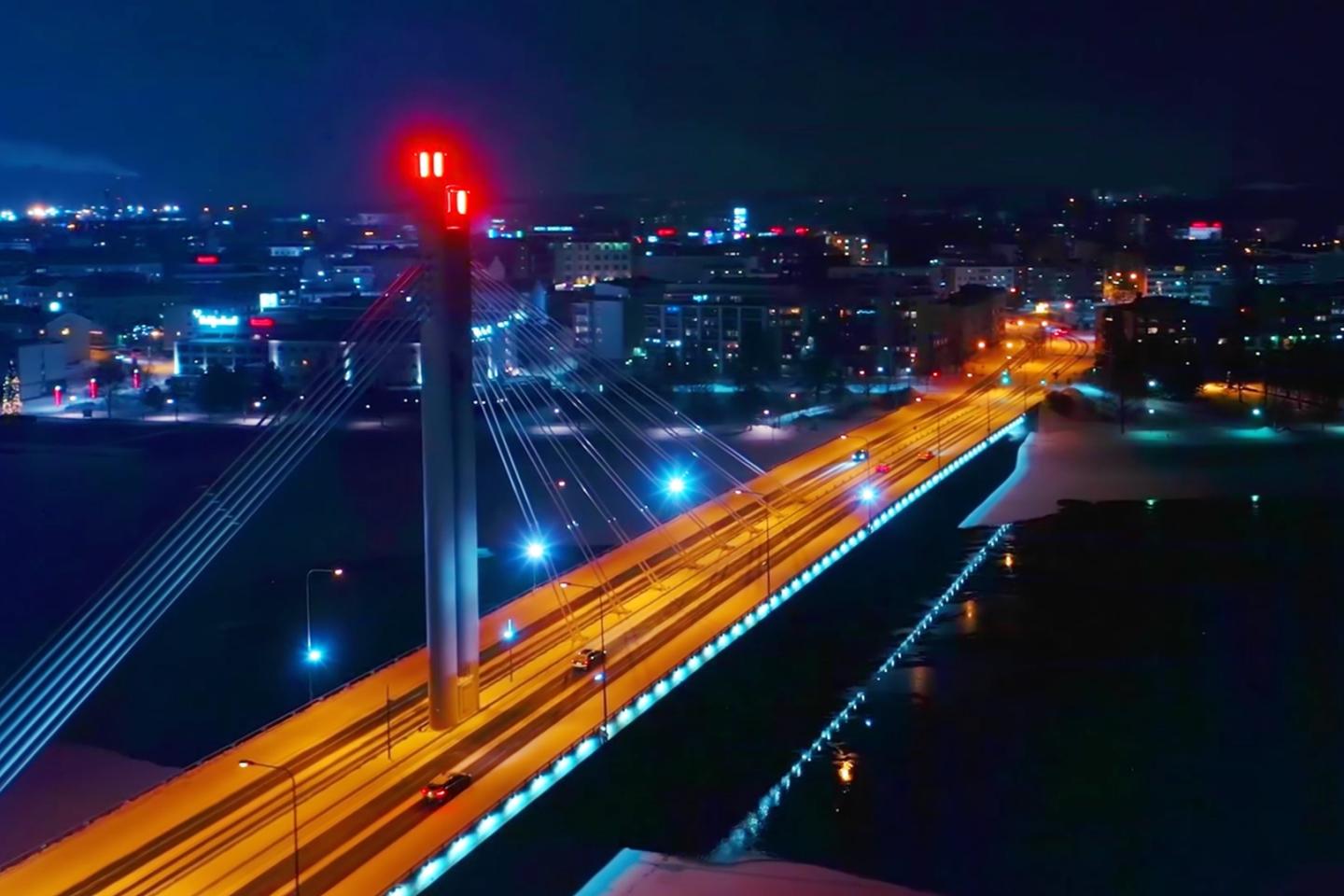 Cityscape by night, with a highway bridge