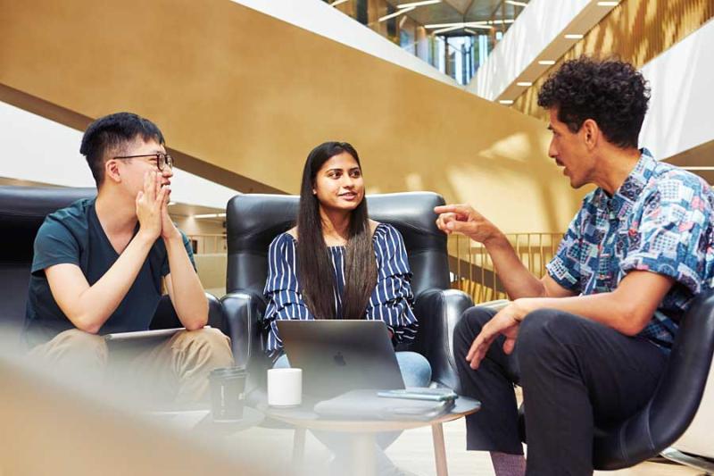 Students chatting at university lobby