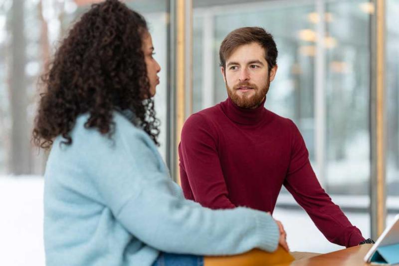 Two students chatting at university cafeteria