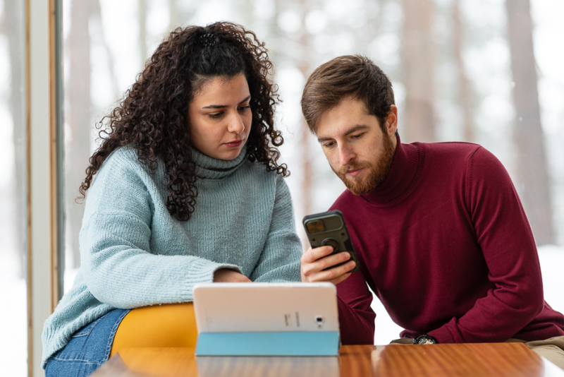 Two students checking things online