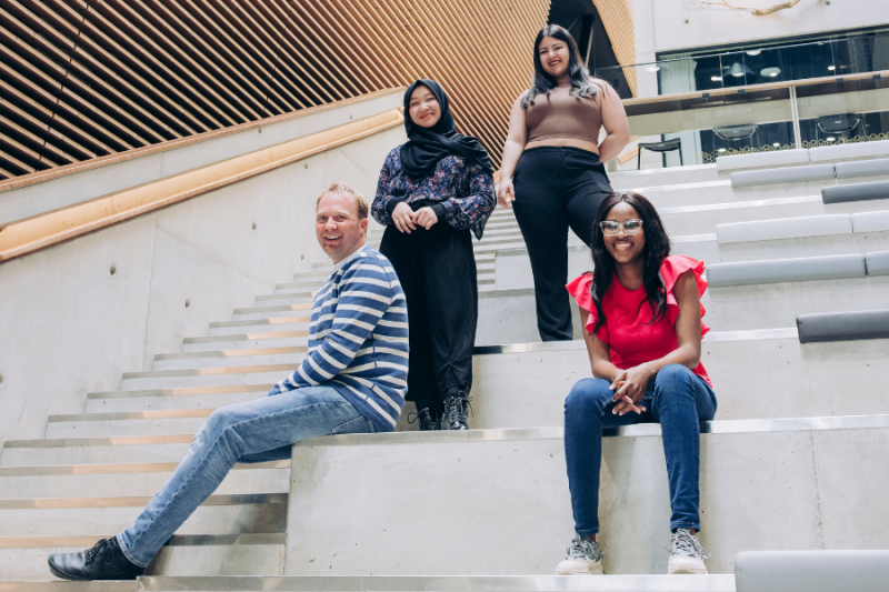 A group os students posing at a university staircase