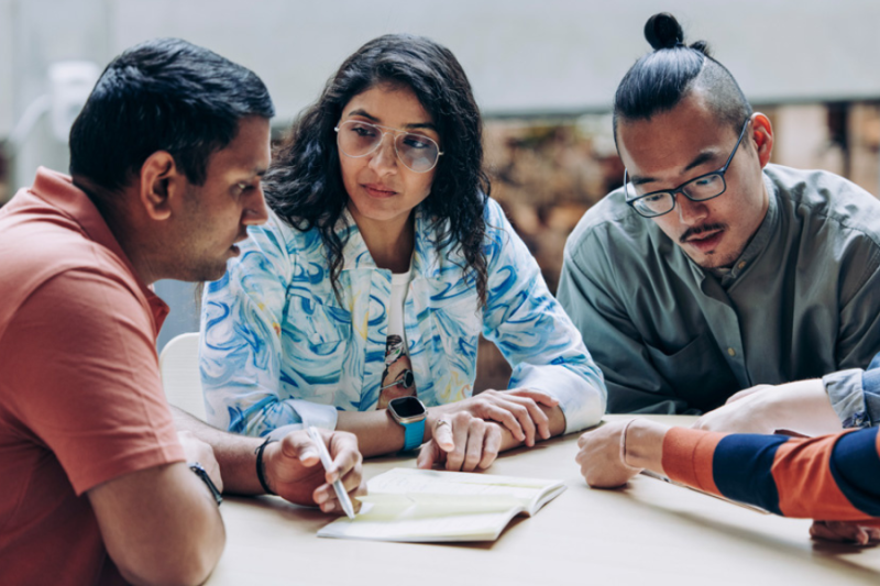 A group of students chatting at a table