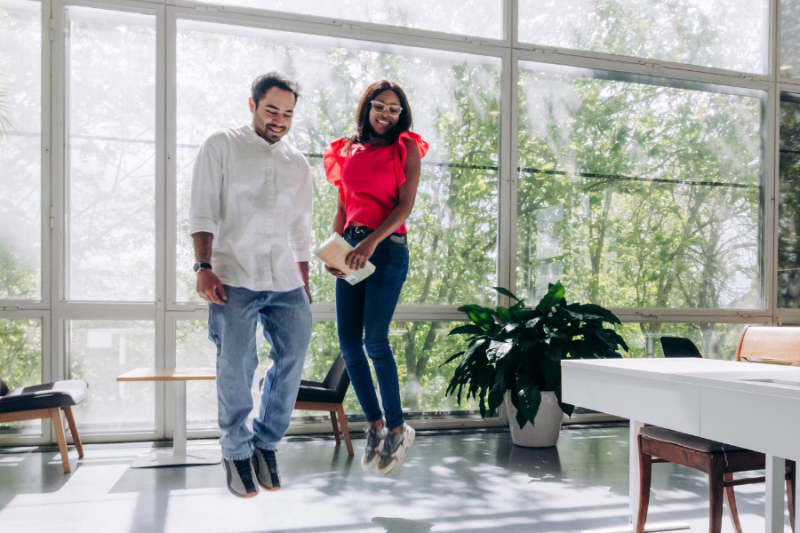 Two students at university jumping into air